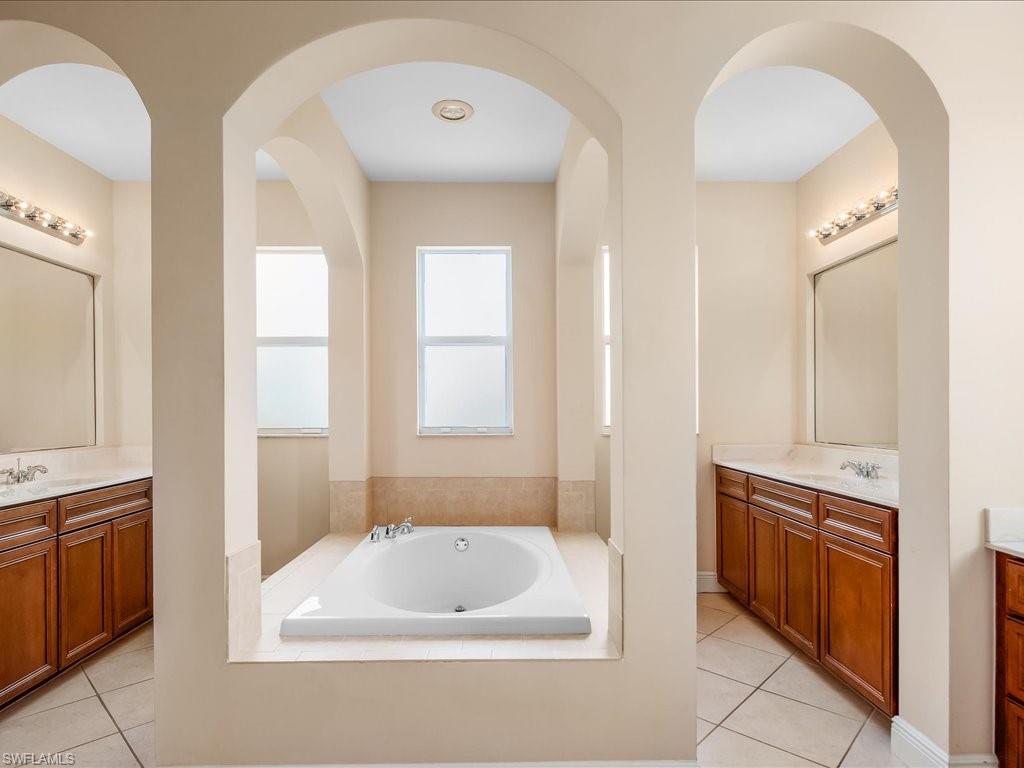 2055 Par Drive Naples, FL 34120 - Photo 11 of 32 a bathroom with a bathtub and a sink