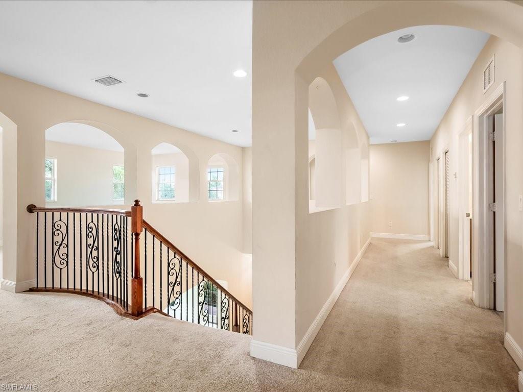 2055 Par Drive Naples, FL 34120 - Photo 13 of 32 a view of a hallway with windows