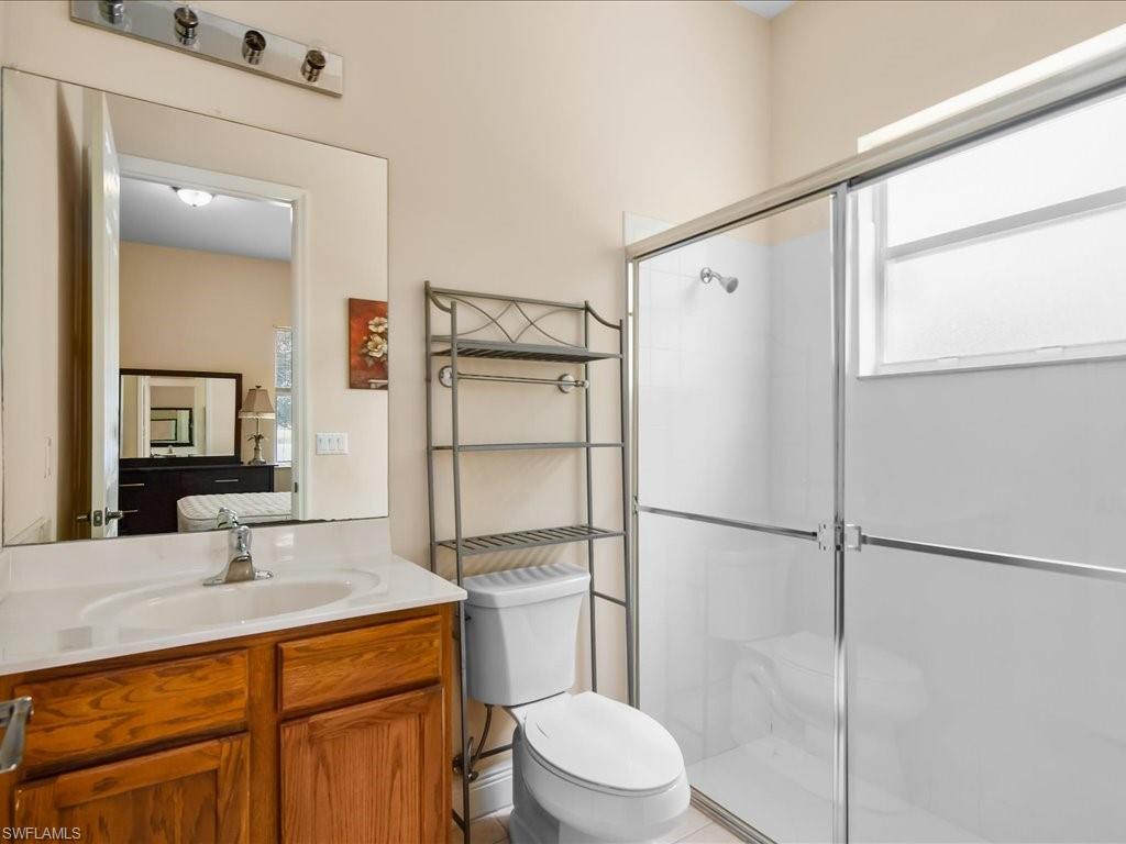 2055 Par Drive Naples, FL 34120 - Photo 15 of 32 a bathroom with a sink toilet and shower