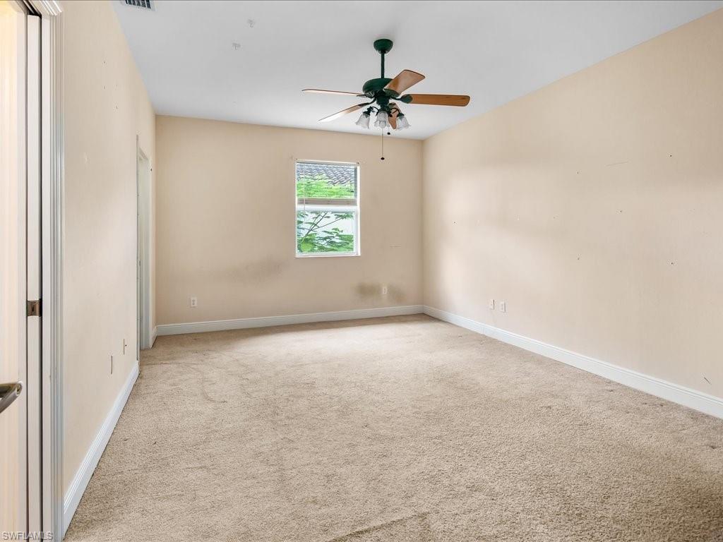 2055 Par Drive Naples, FL 34120 - Photo 18 of 32 an empty room with a window and a fan