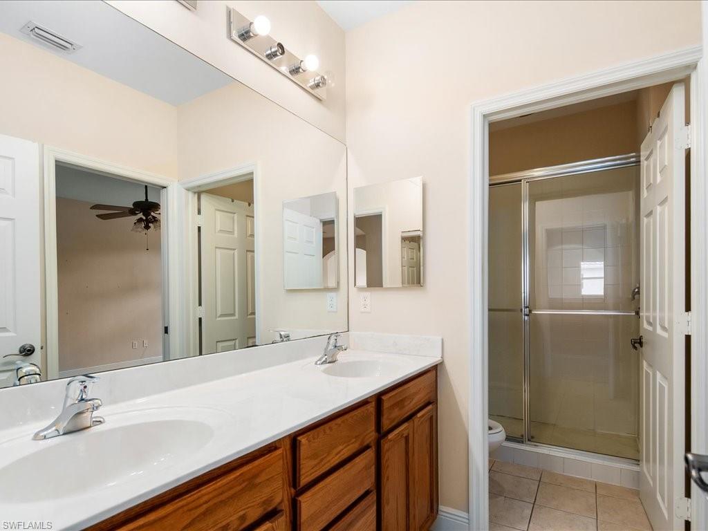 2055 Par Drive Naples, FL 34120 - Photo 19 of 32 a bathroom with a sink and a mirror