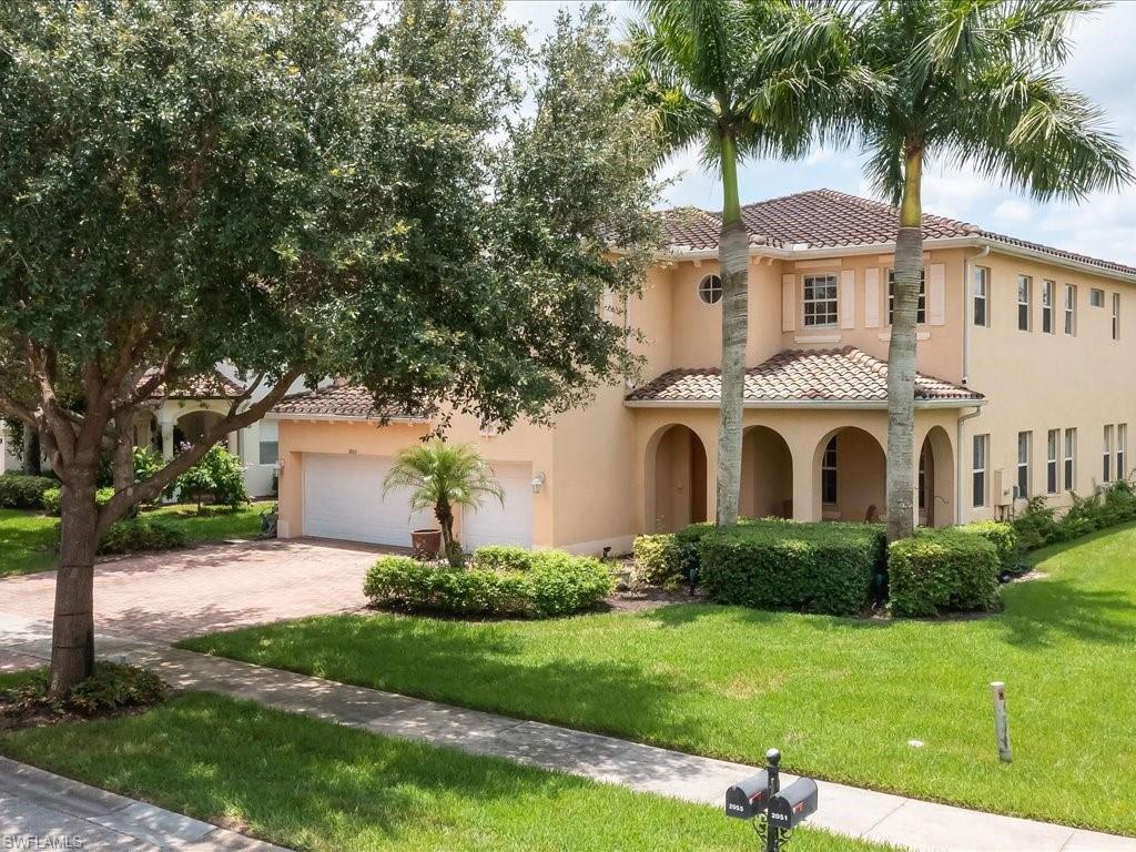2055 Par Drive Naples, FL 34120 - Photo 31 of 32 a front view of a house with a garden and trees