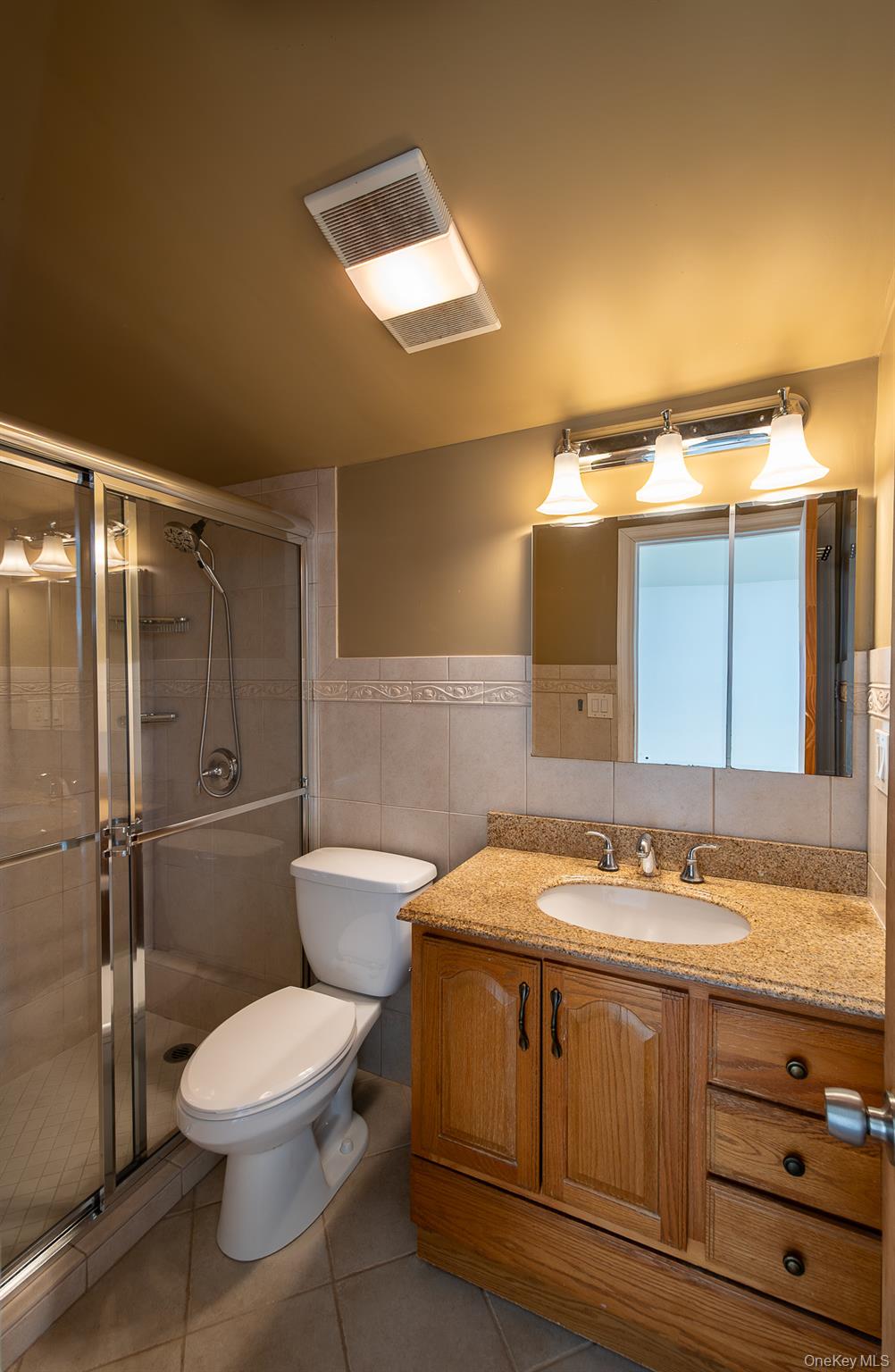 83 Edgepark Road White Plains, NY 10603 - Photo 18 of 25 a bathroom with a sink a toilet and shower