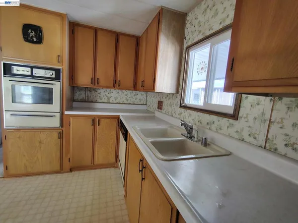 a kitchen with a sink and a refrigerator