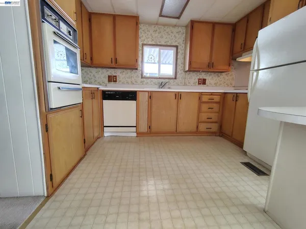 a kitchen with a cabinets window and refrigerator