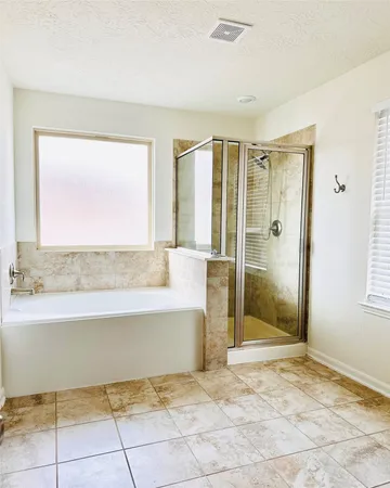 a view of a bathroom with a tub shower and a sink