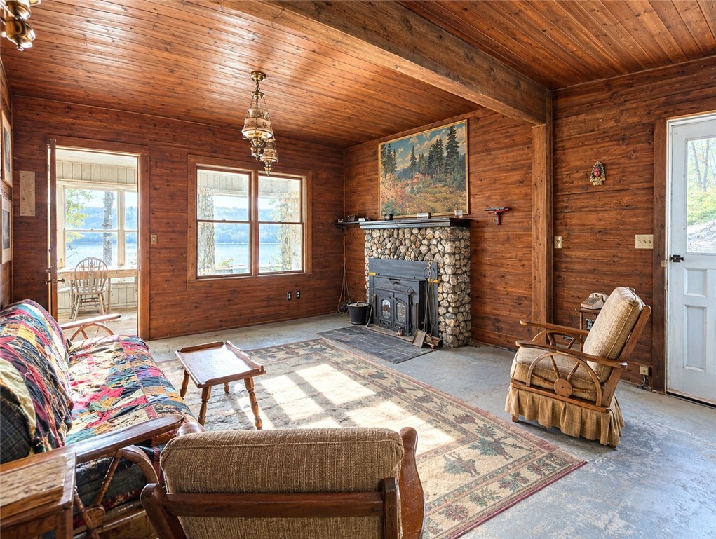 4389 Mickel Parcel A Road Burdett, NY 14818 - Photo 7 of 13 Classic Cottage Living Room with Stone Fireplace and Lake View – AI Enhanced for Light