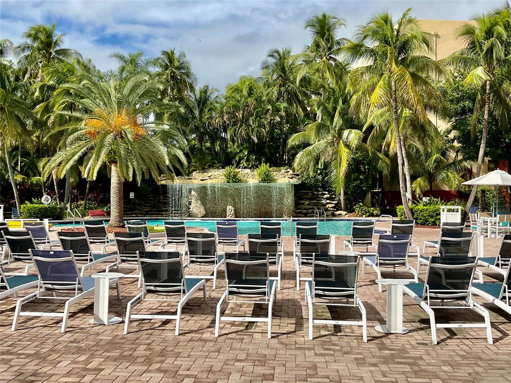 9517 Fontainebleau Boulevard, Unit 581315 Miami, FL 33172 - Photo 11 of 17 a view of a chairs and table in the patio