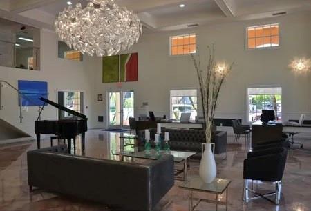 9517 Fontainebleau Boulevard, Unit 581315 Miami, FL 33172 - Photo 15 of 17 a living room with fireplace furniture and a chandelier