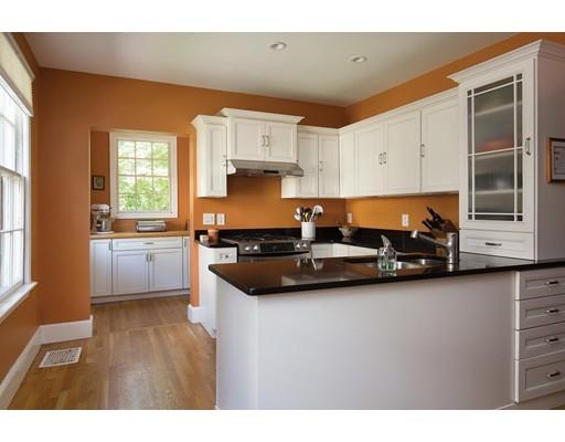 255 Clinton Road Brookline, MA 02445 - Photo 8 of 13 a kitchen with stainless steel appliances granite countertop a stove a sink and a microwave