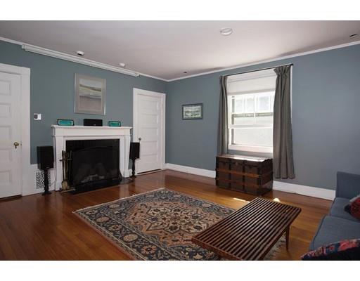 255 Clinton Road Brookline, MA 02445 - Photo 10 of 13 a living room with a fireplace and a table