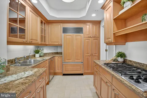 a kitchen with wooden cabinets and a stove top oven