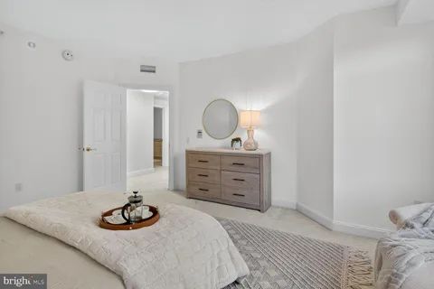 a bedroom with a bed and a dresser