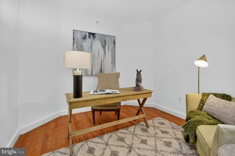 a kitchen with stainless steel appliances a sink a refrigerator and cabinets