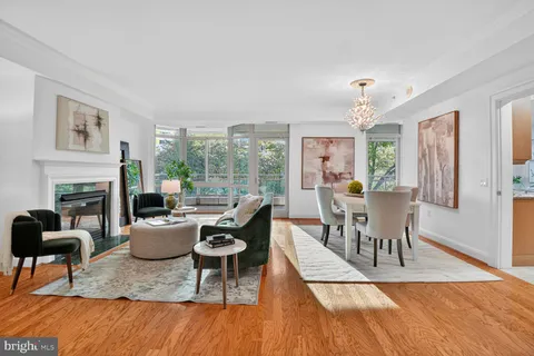 a living room with fireplace furniture and a wooden floor