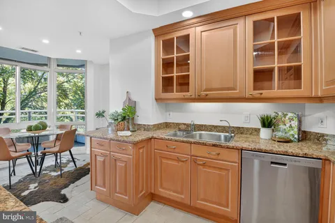 a kitchen with granite countertop cabinets table and chairs