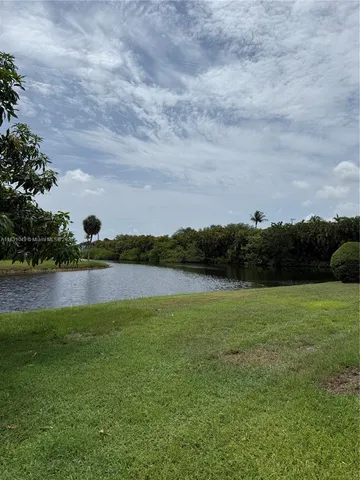 a view of lake with green space
