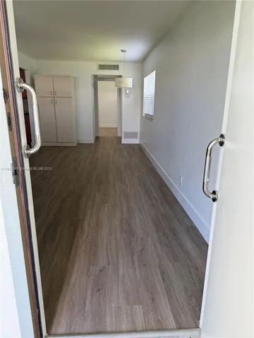 a view of room with wooden floor