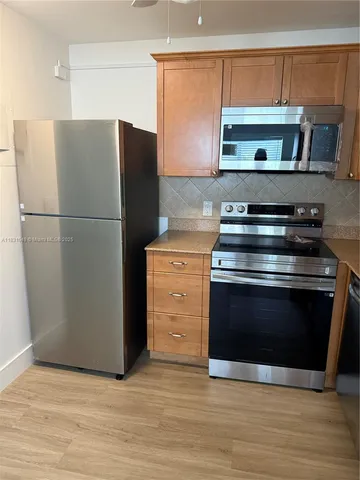 a kitchen with a stove and a microwave