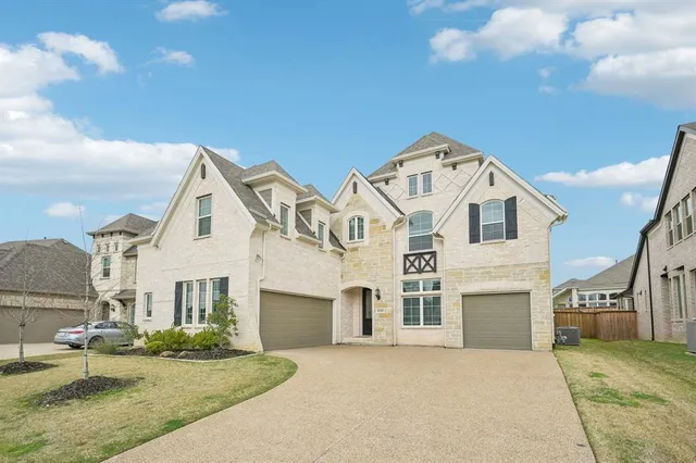 a view of a white house with a yard and large tree