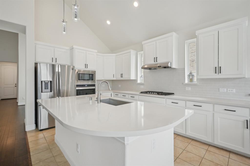 1640 Ranch House Road Celina, TX 75009 - Photo 15 of 40 a kitchen with stainless steel appliances granite countertop a sink stove and refrigerator