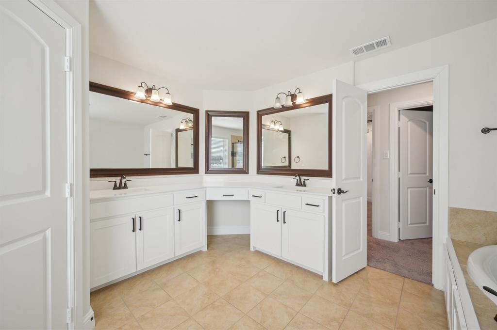 1640 Ranch House Road Celina, TX 75009 - Photo 34 of 40 a spacious bathroom with a double vanity sink and a mirror