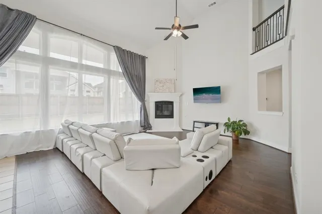 a living room with furniture large window and flat screen tv
