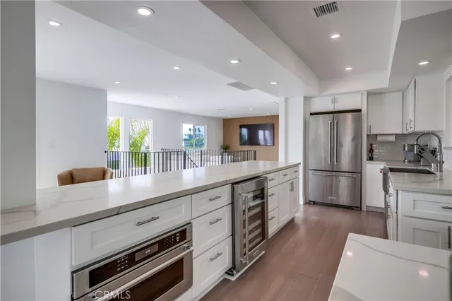 a kitchen with stainless steel appliances a sink stove and refrigerator