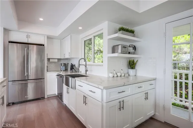 a kitchen with a sink window and refrigerator