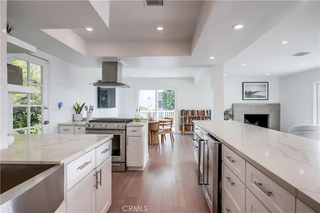 a kitchen with stainless steel appliances granite countertop sink stove refrigerator and cabinets