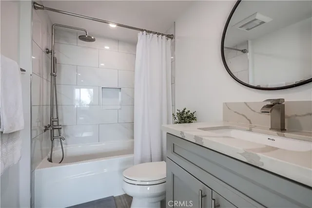 a bedroom with furniture and a large window