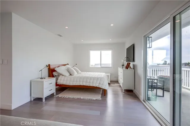 a spacious bedroom with a bed and a potted plant