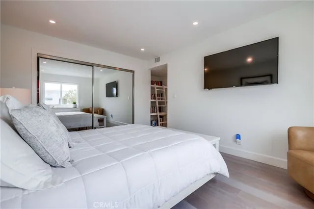 a bathroom with a granite countertop sink a toilet and a mirror