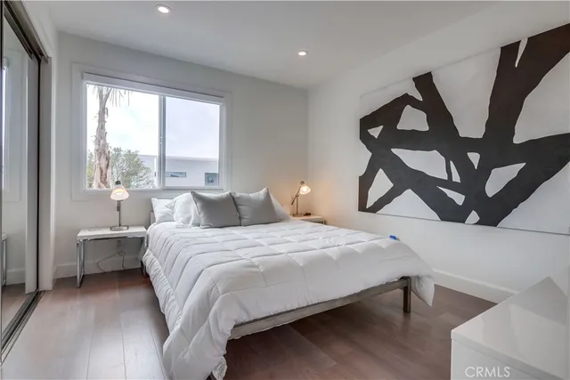 a bedroom with two beds and a night stand