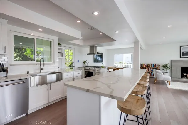 a view of kitchen with sink and refrigerator