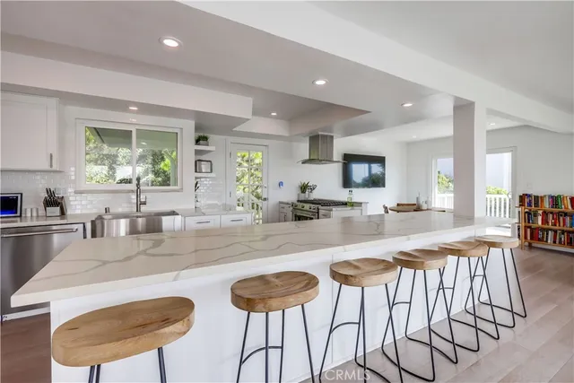 a kitchen with granite countertop a table and chairs in it