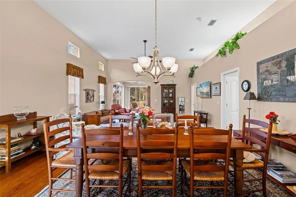 a living room with furniture wooden floor and a table