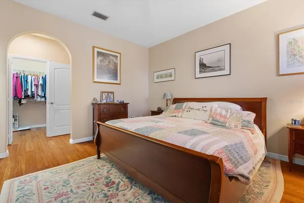 a bedroom with a bed and dresser with mirror