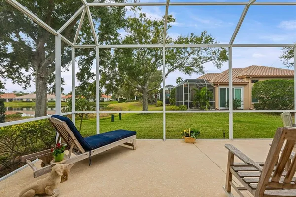 a backyard of a house with table and chairs
