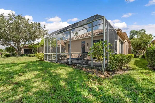 a view of a house with backyard and porch