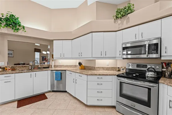a kitchen with a sink cabinets and stainless steel appliances