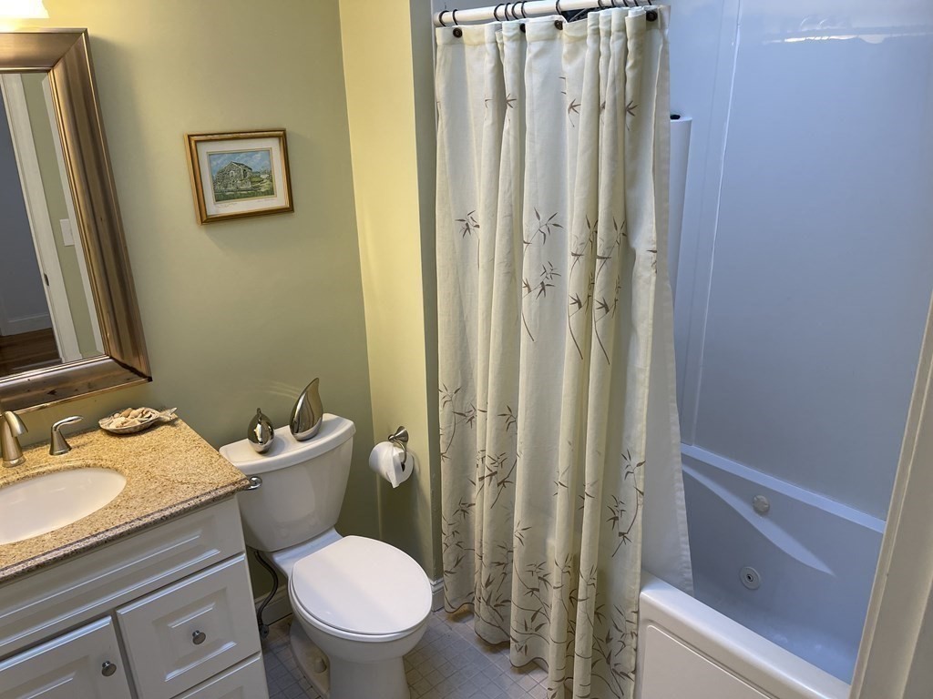 32 Birch Way Mashpee, MA 02649 - Photo 14 of 31 a white toilet sitting next to a bathroom sink