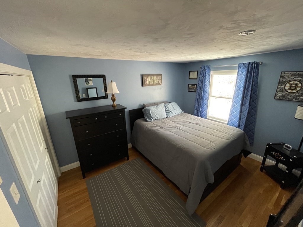 32 Birch Way Mashpee, MA 02649 - Photo 17 of 31 a bedroom with a bed and a dresser