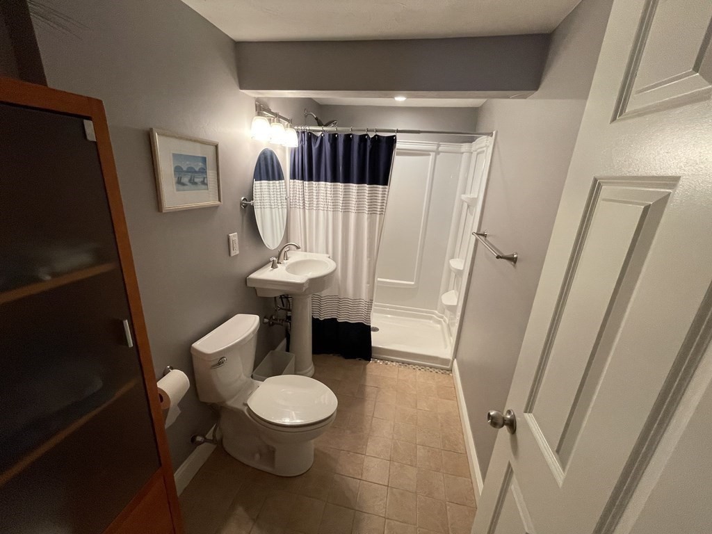 32 Birch Way Mashpee, MA 02649 - Photo 25 of 31 a bathroom with a sink and a mirror