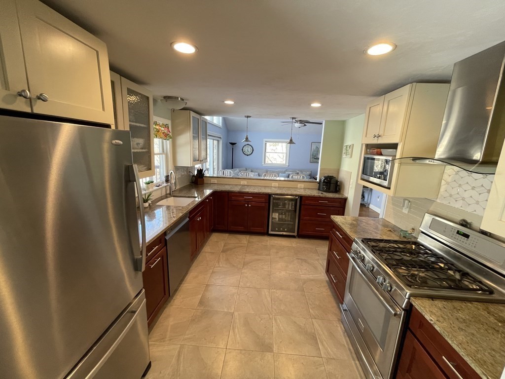 32 Birch Way Mashpee, MA 02649 - Photo 7 of 31 a large kitchen with stainless steel appliances a refrigerator and a sink