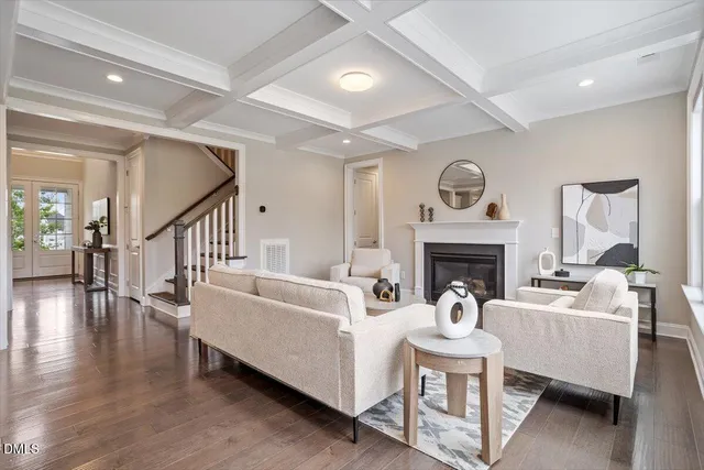 a living room with furniture a fireplace and a large window