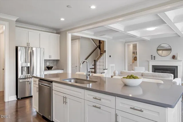 a kitchen with stainless steel appliances a sink stove and refrigerator