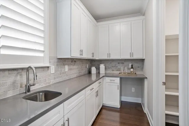 a kitchen with sink cabinets and window