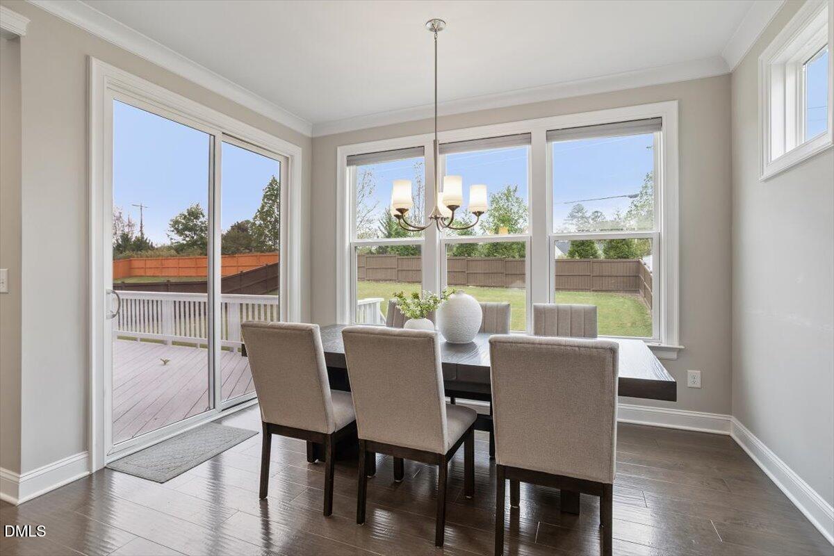 2844 Spring Shade Road Apex, NC 27523 - Photo 20 of 48 a view of a dining room with furniture large windows and wooden floor