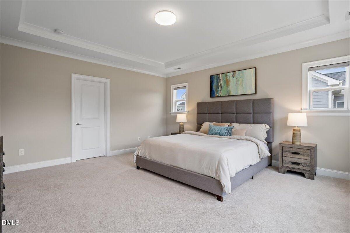 2844 Spring Shade Road Apex, NC 27523 - Photo 27 of 48 a bedroom with a bed and a lamp on dresser